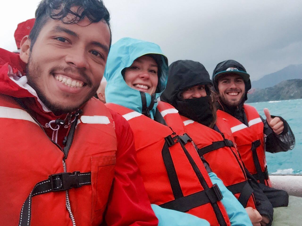Four people on a boat well covered against the cold and the water