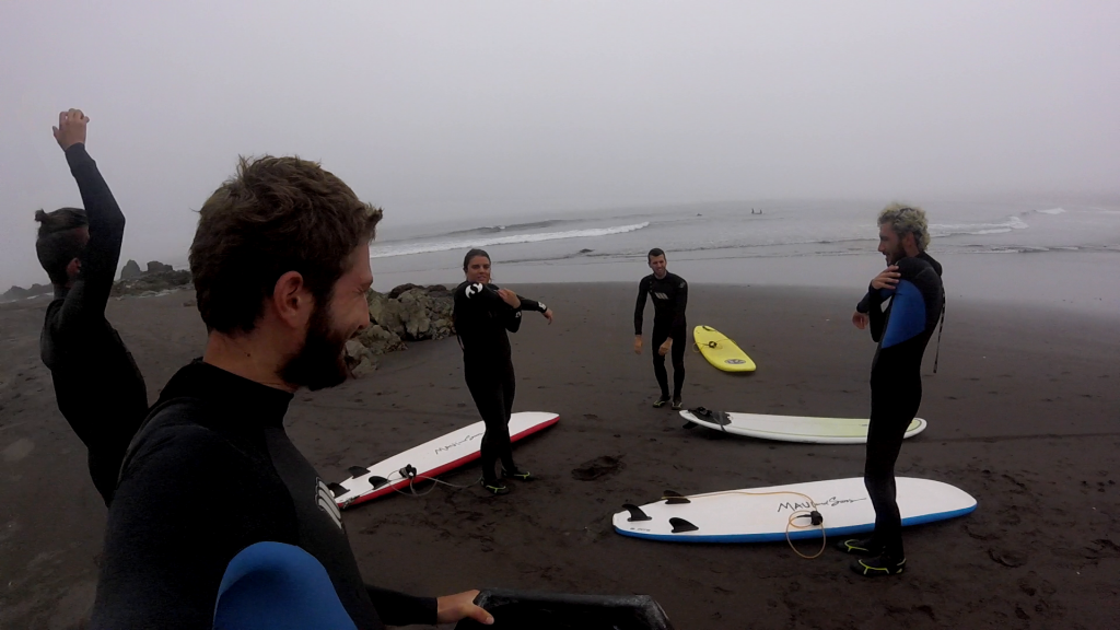 5 people warming up for surfing