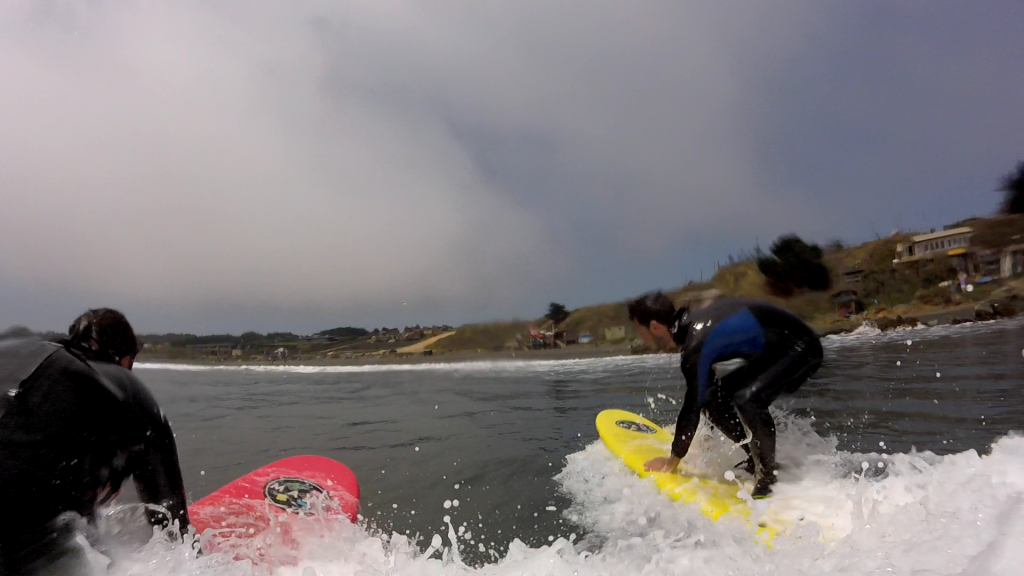 On my board while a wave is pushing me