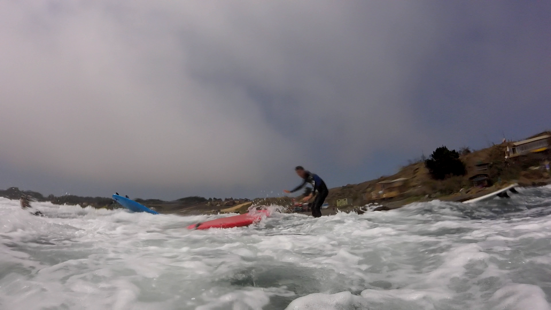 Standing on my board and surfing to the coast.