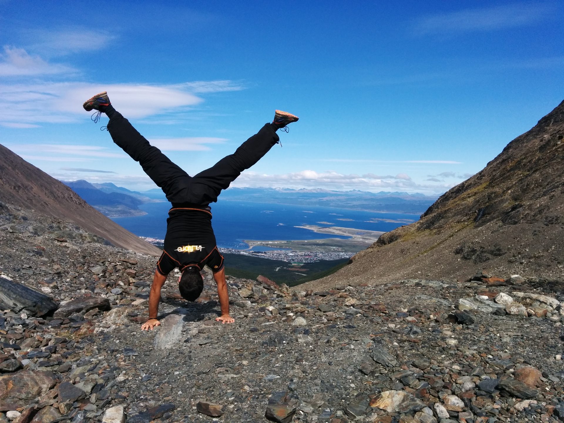 I am in balanced on the top of Glacier Martial with Ushuaia in the bacjground