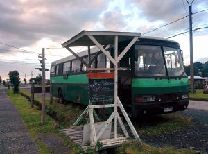 A green bus has been transformed in a café.