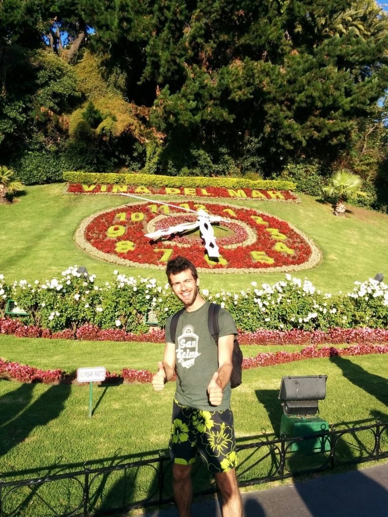 A giant clock on the floor made with flowers.