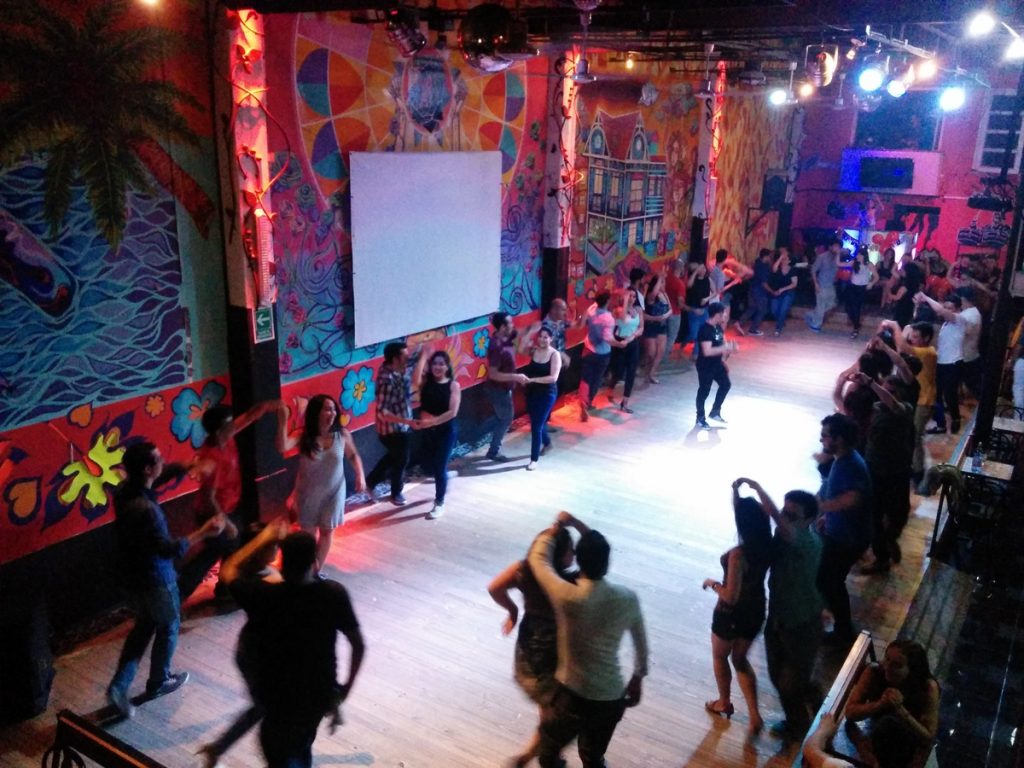 A dancefloor in a club with dancers