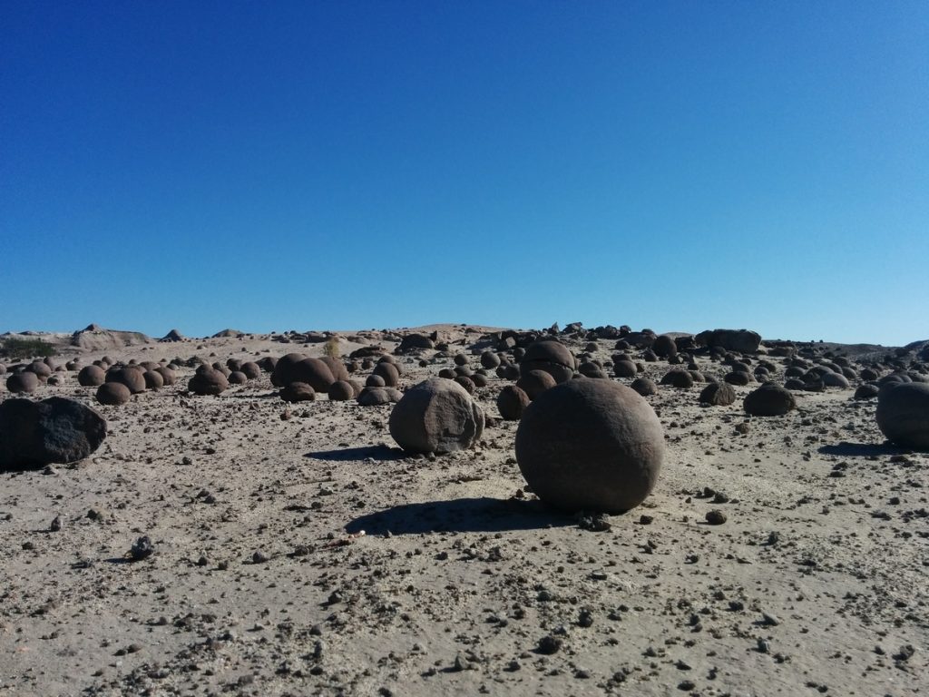Rocks on the ground that have a shape of ball
