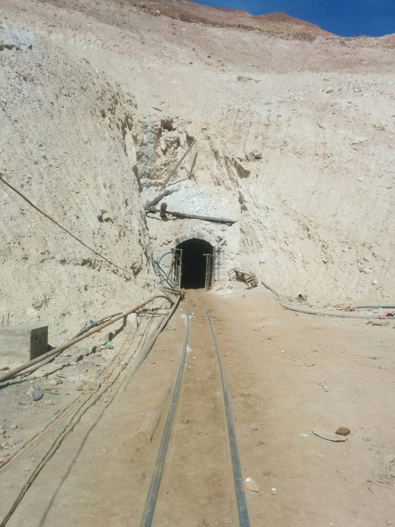 Facing the shadow entrance of the mine